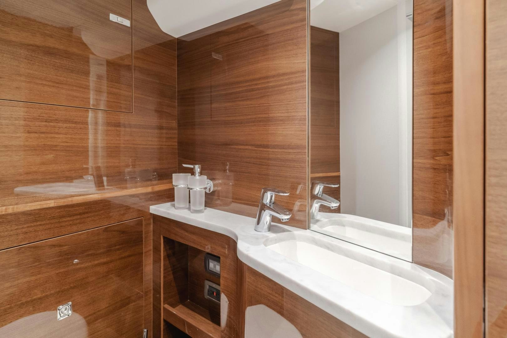 a bathroom with a sink and a mirror aboard Mad Betty 2.0 Yacht for Sale