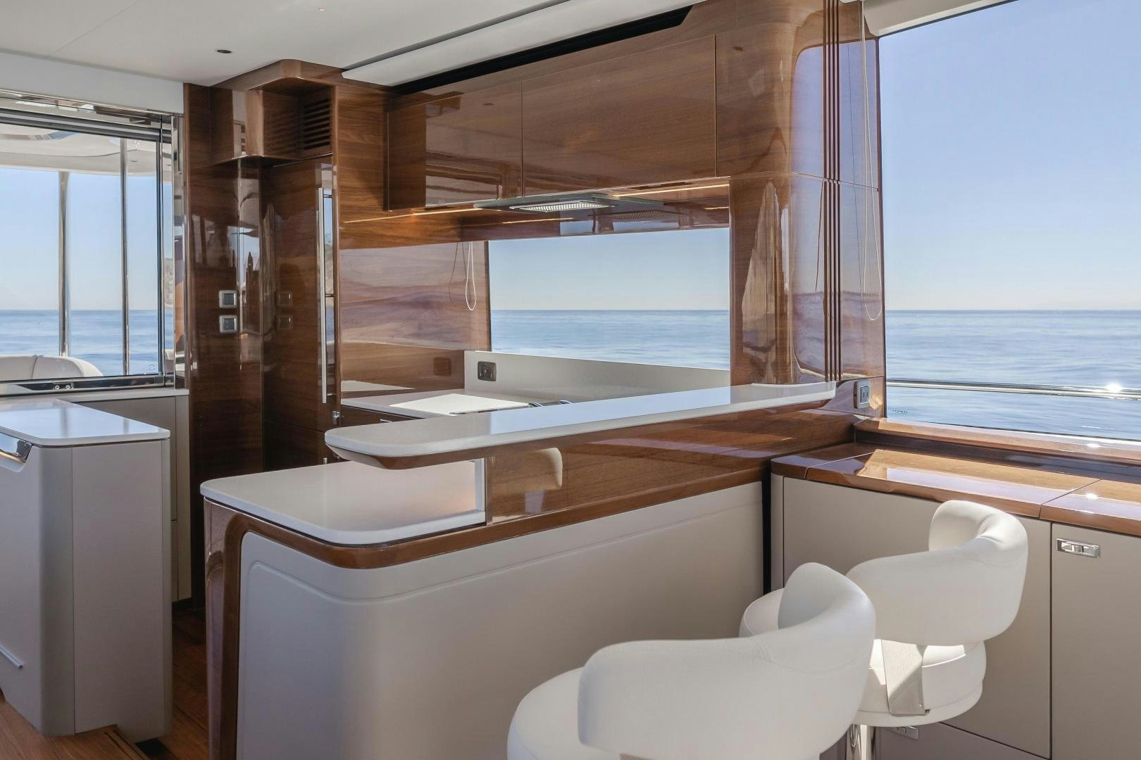 a room with a view of the ocean and a balcony aboard Mad Betty 2.0 Yacht for Sale
