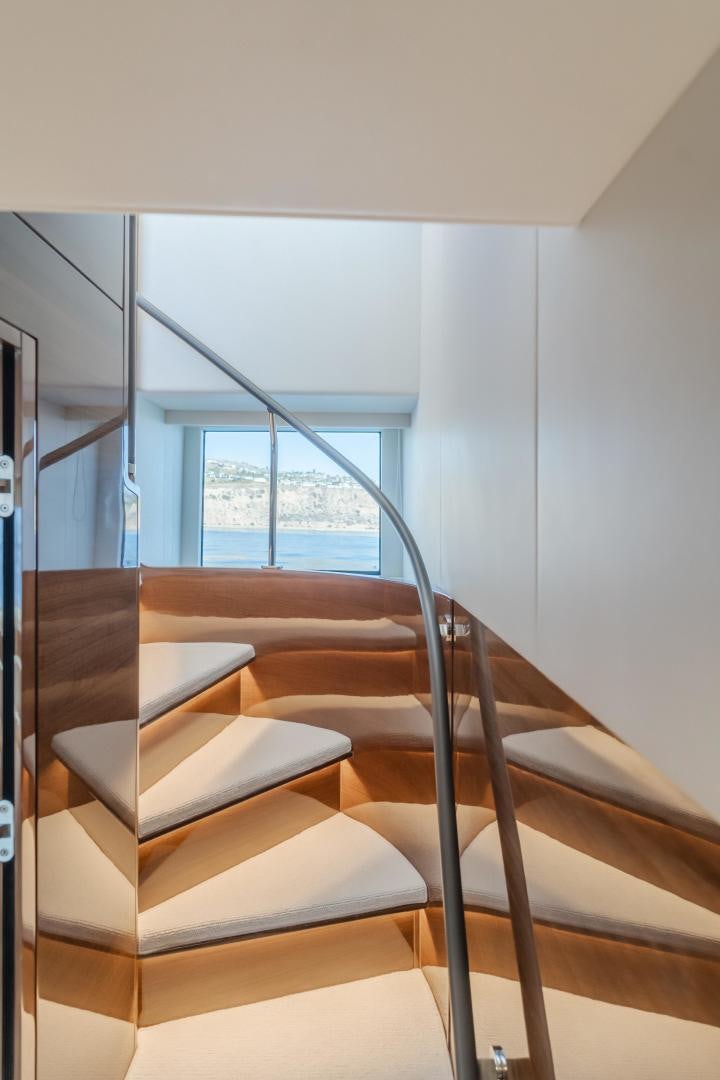 a wooden staircase with a window aboard Mad Betty 2.0 Yacht for Sale