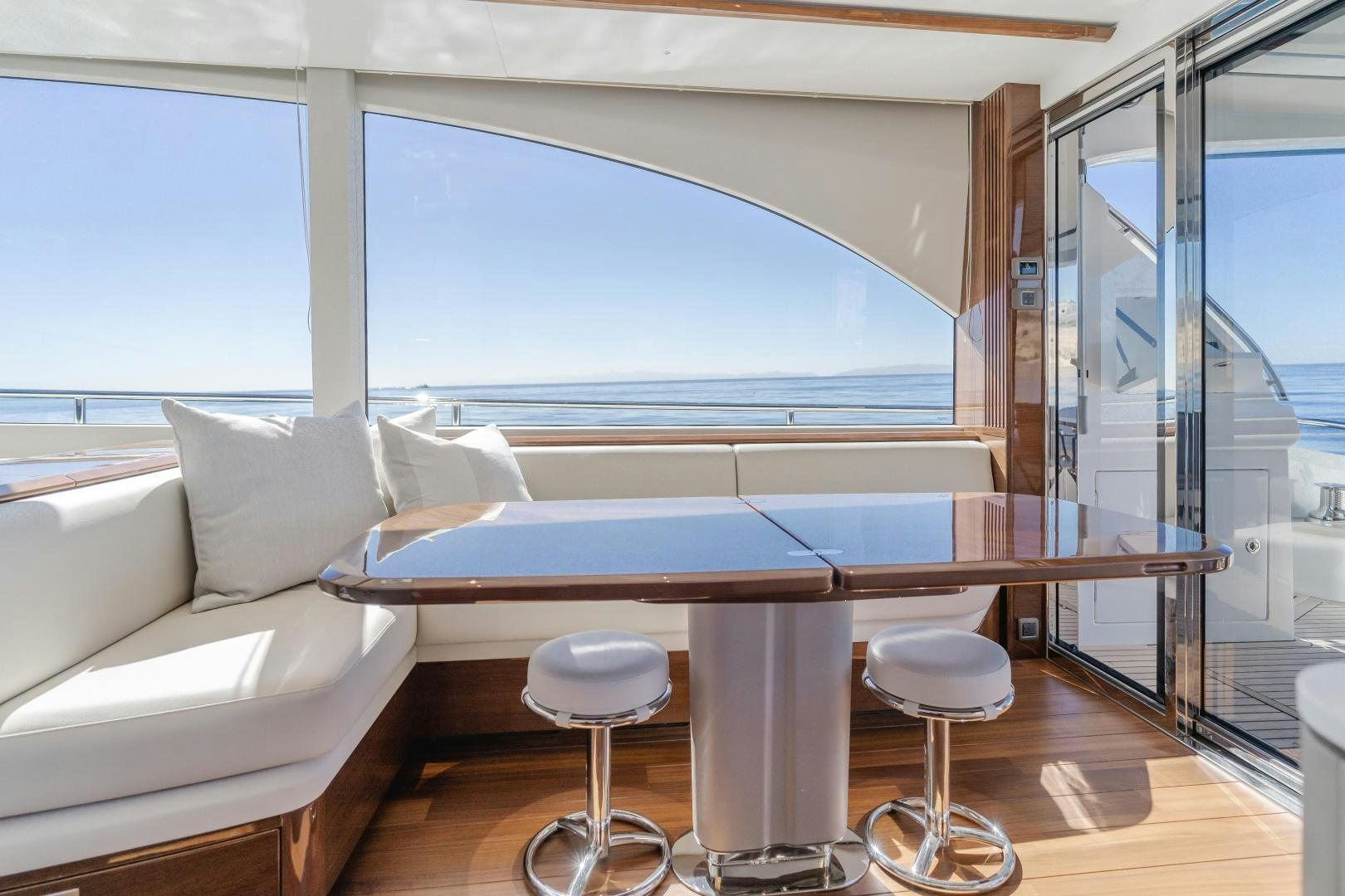a room with a couch and a table and chairs aboard Mad Betty 2.0 Yacht for Sale