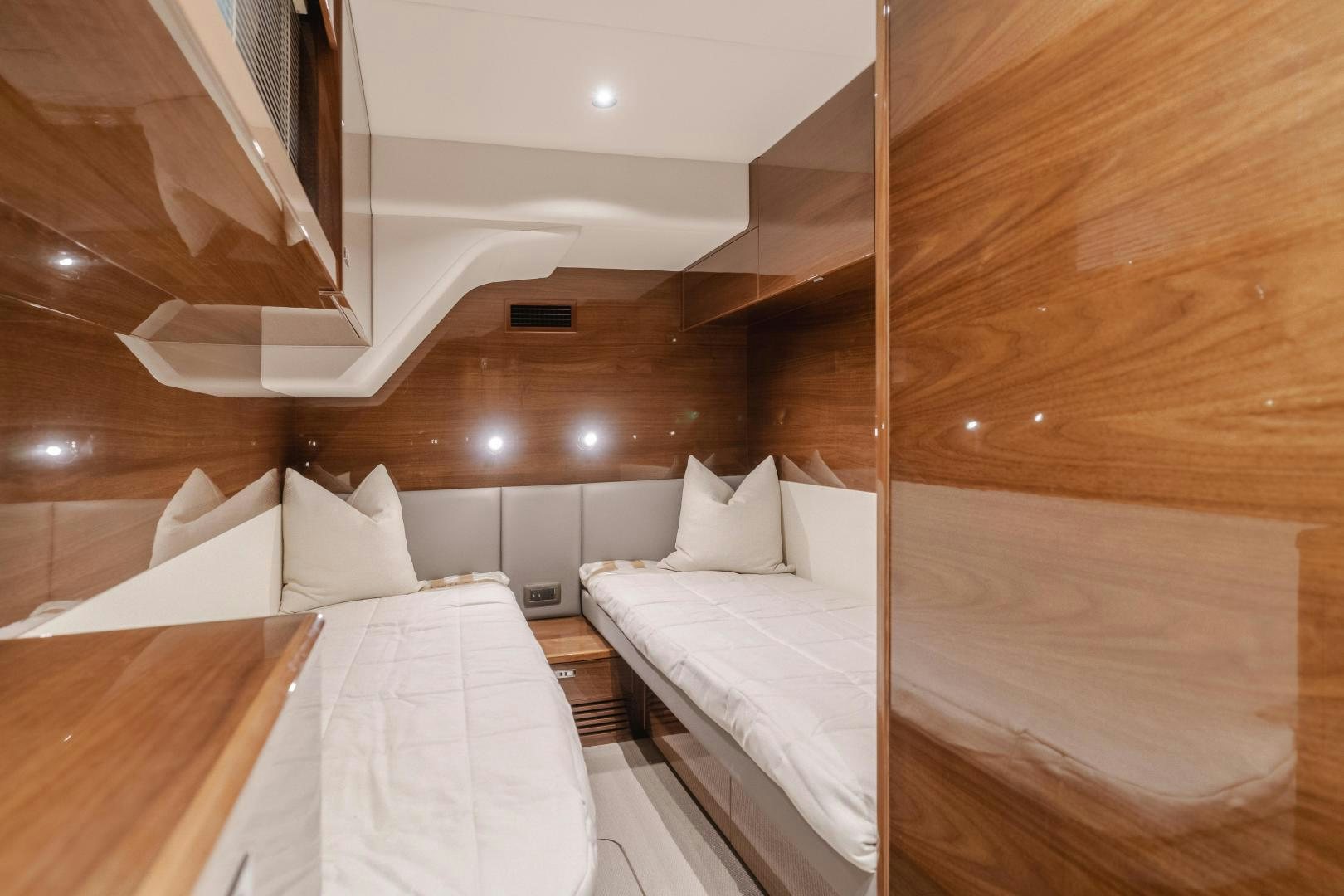 a room with beds and a wood wall aboard Mad Betty 2.0 Yacht for Sale