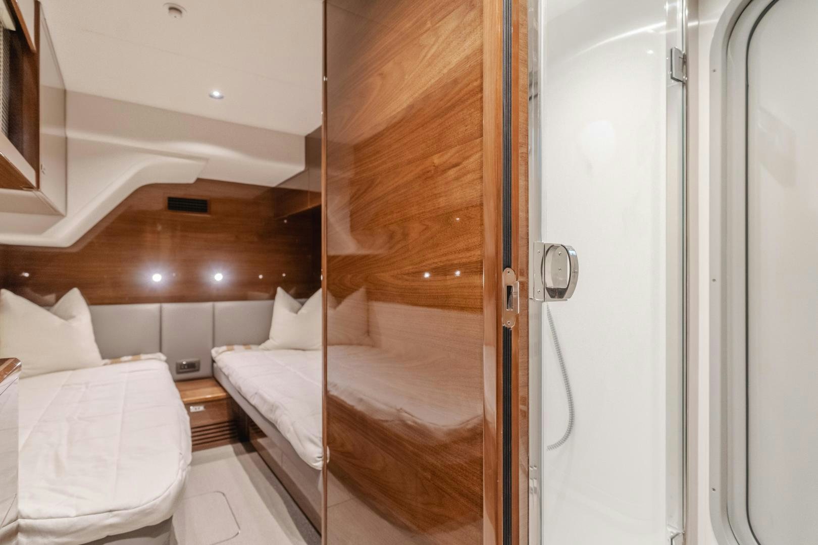 a room with a bed and a mirror aboard Mad Betty 2.0 Yacht for Sale