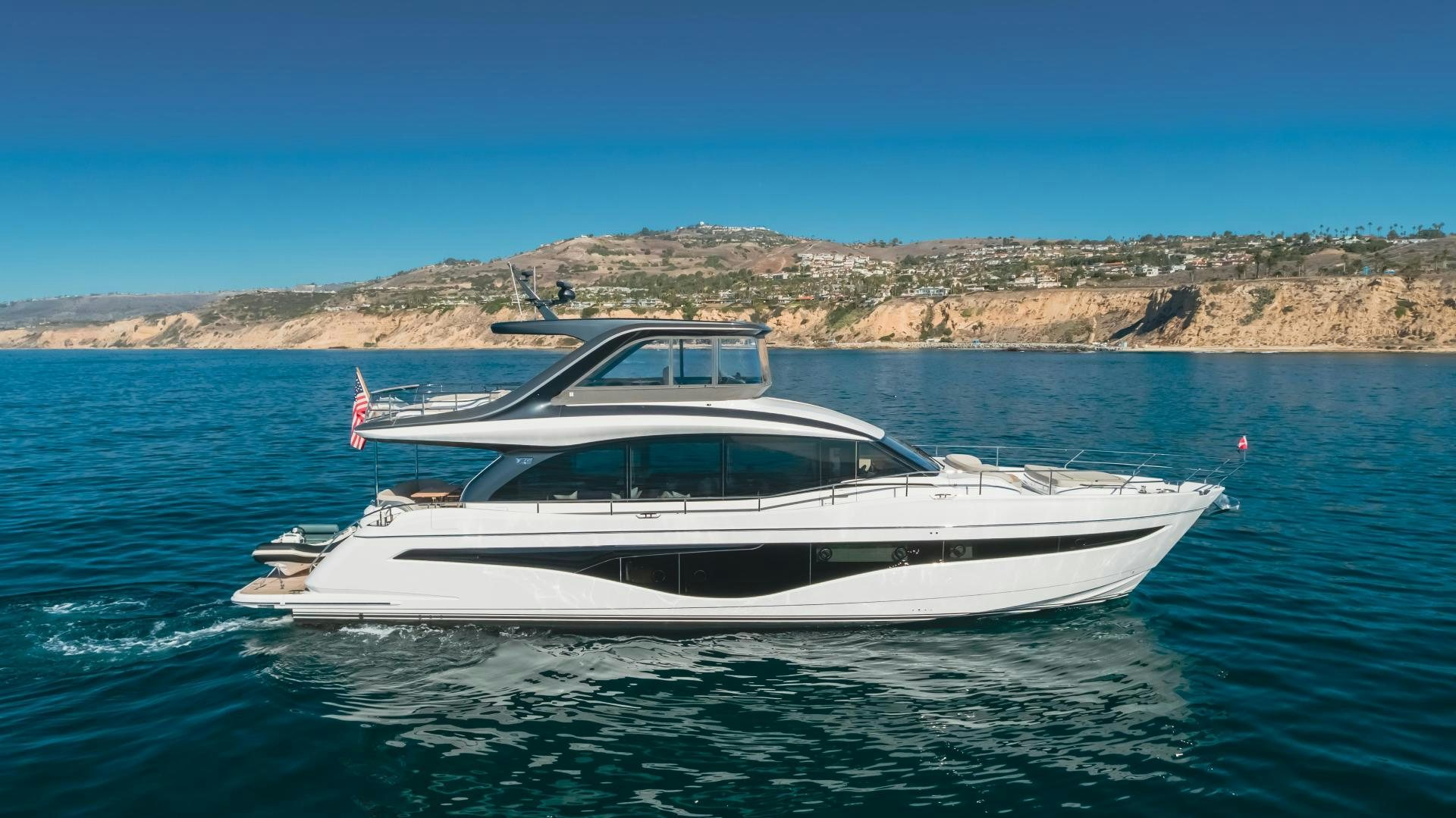 a white boat on the water aboard Mad Betty 2.0 Yacht for Sale