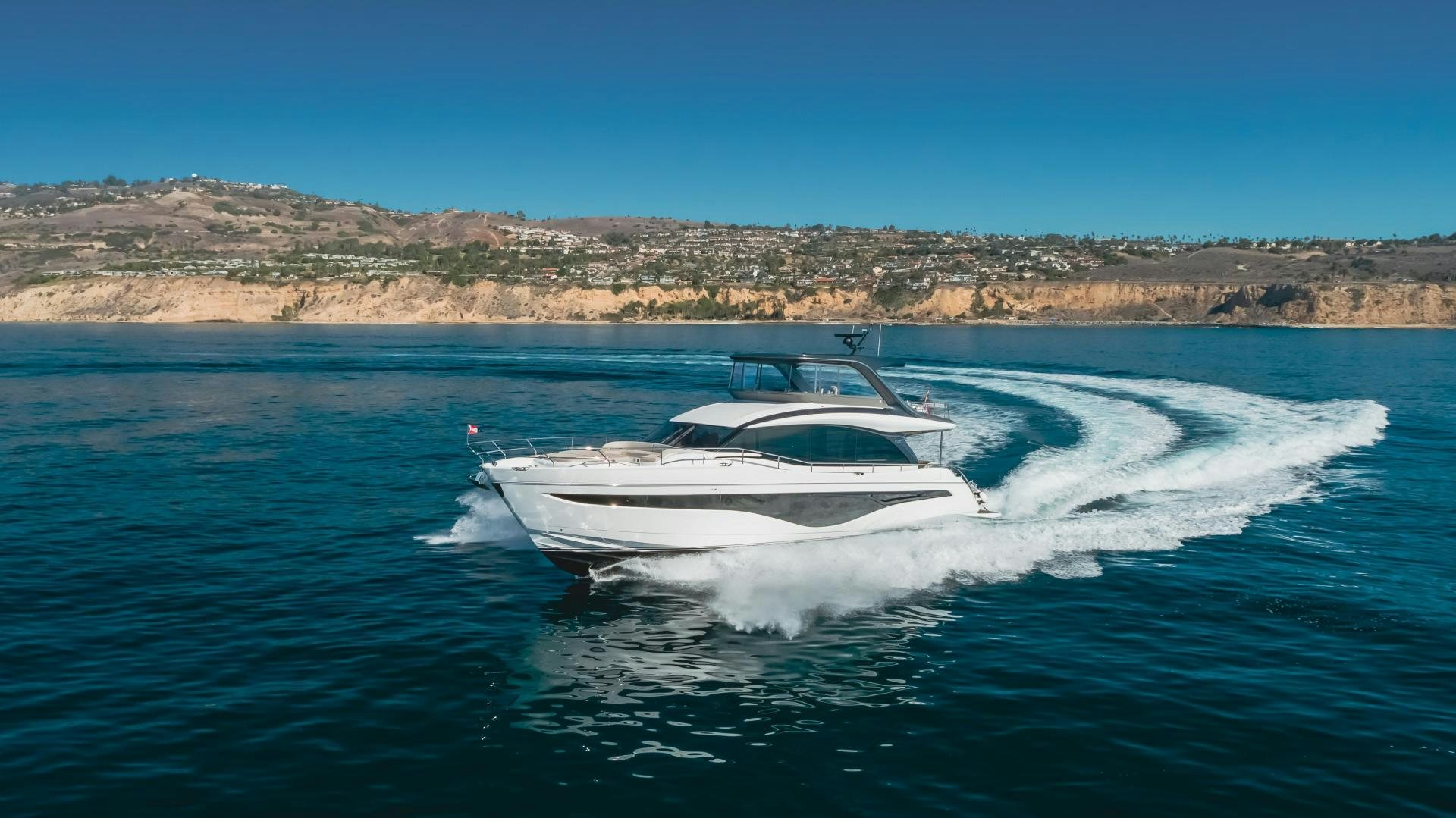 a white boat on the water aboard Mad Betty 2.0 Yacht for Sale