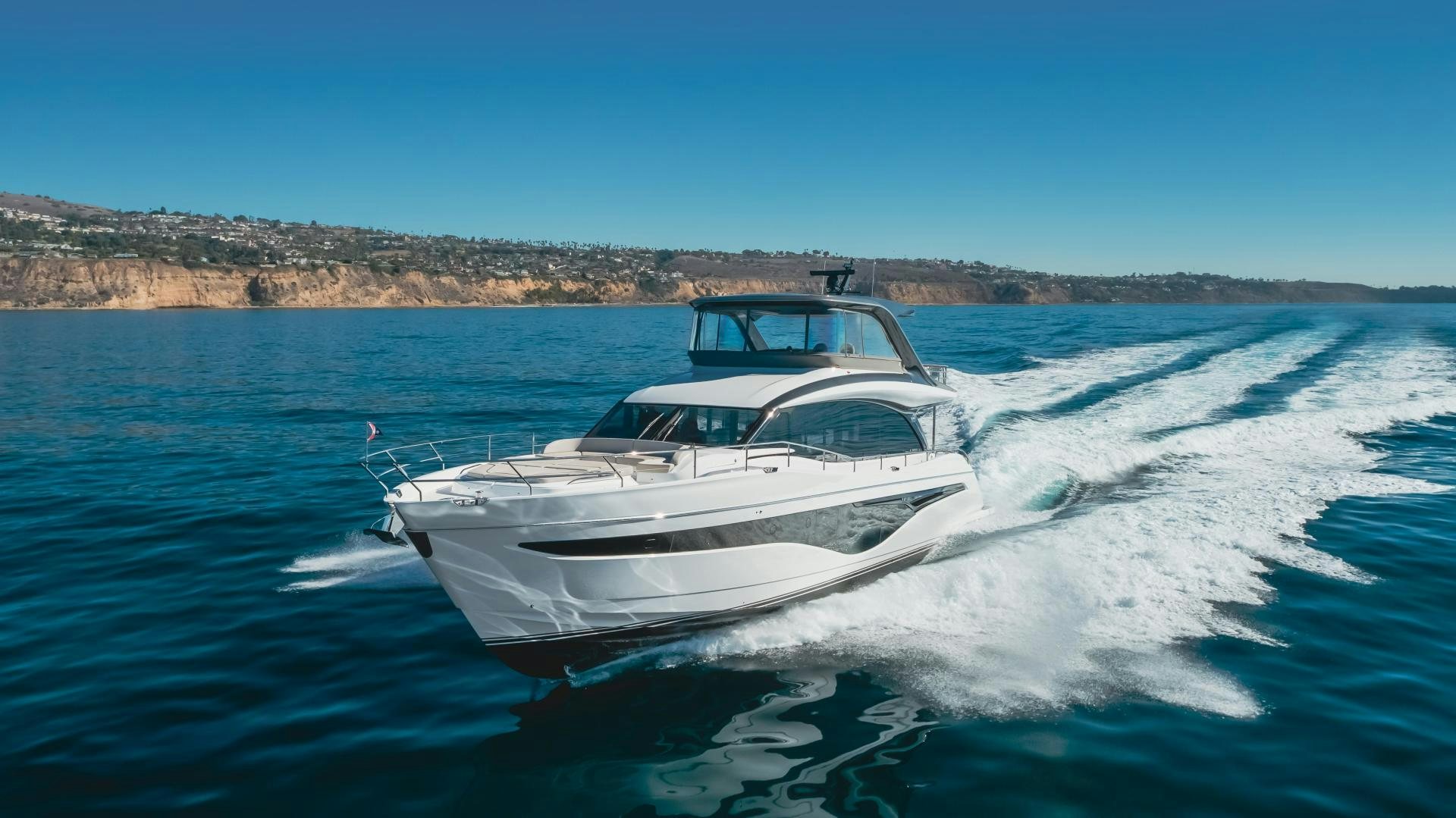 a white yacht on the water aboard Mad Betty 2.0 Yacht for Sale