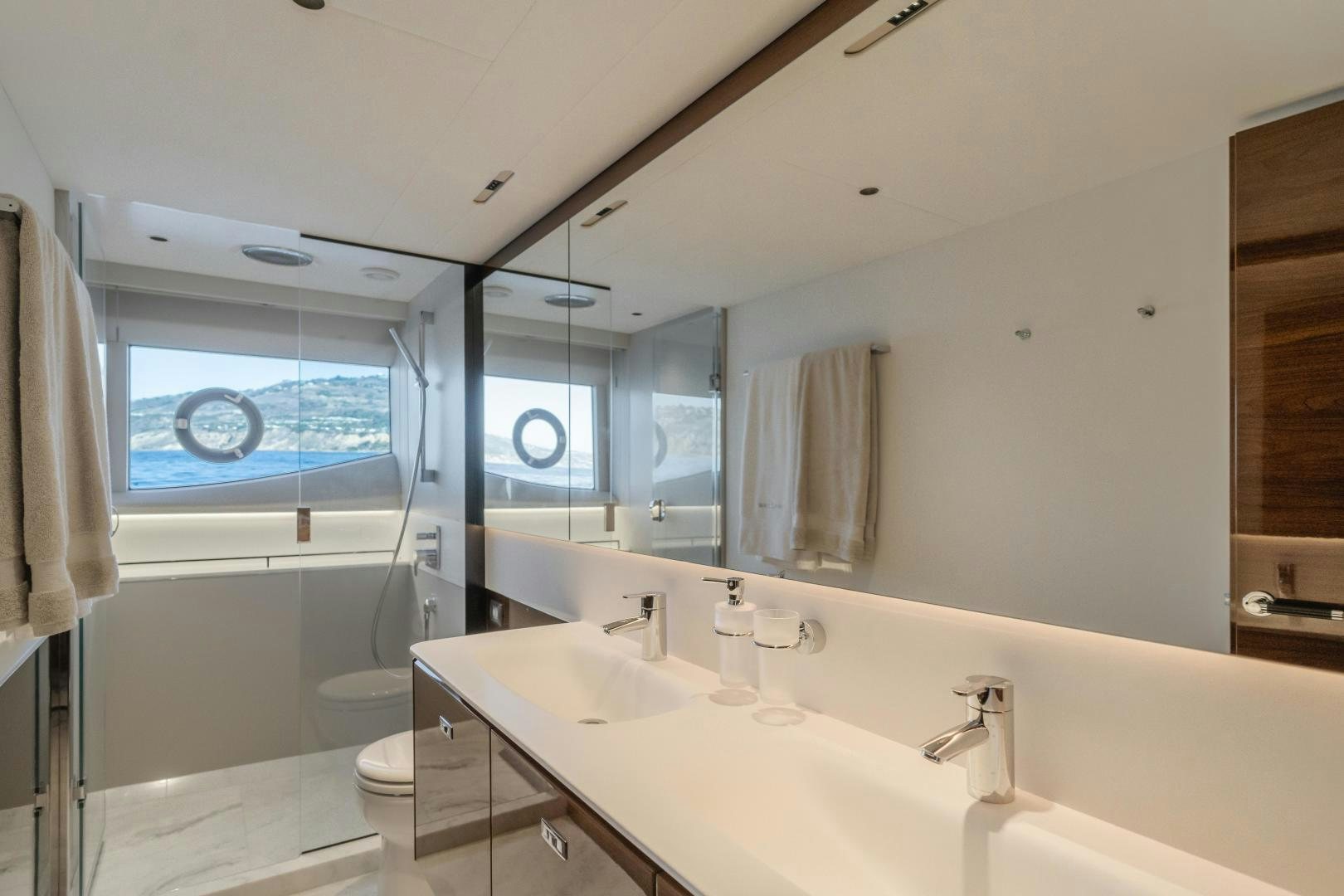 a bathroom with a large mirror aboard Mad Betty 2.0 Yacht for Sale