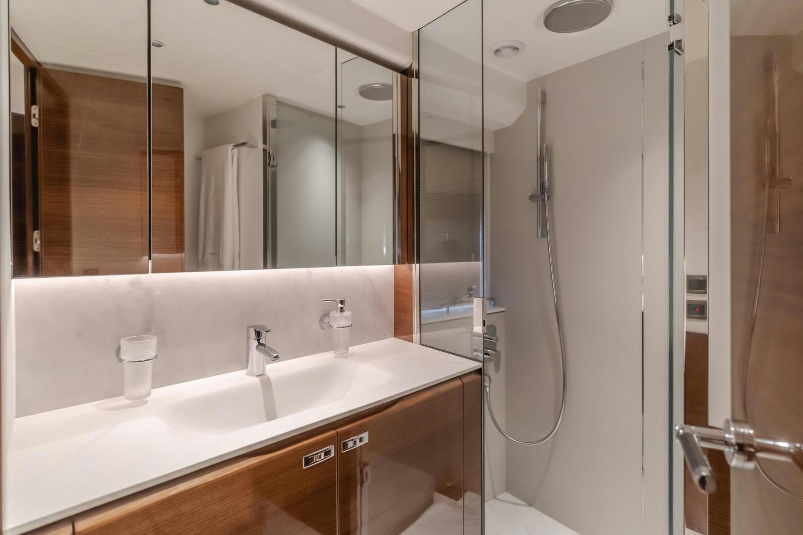a bathroom with a large mirror aboard Mad Betty 2.0 Yacht for Sale