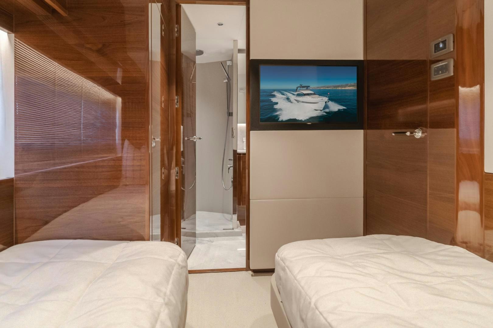 a hotel room with a tv aboard Mad Betty 2.0 Yacht for Sale
