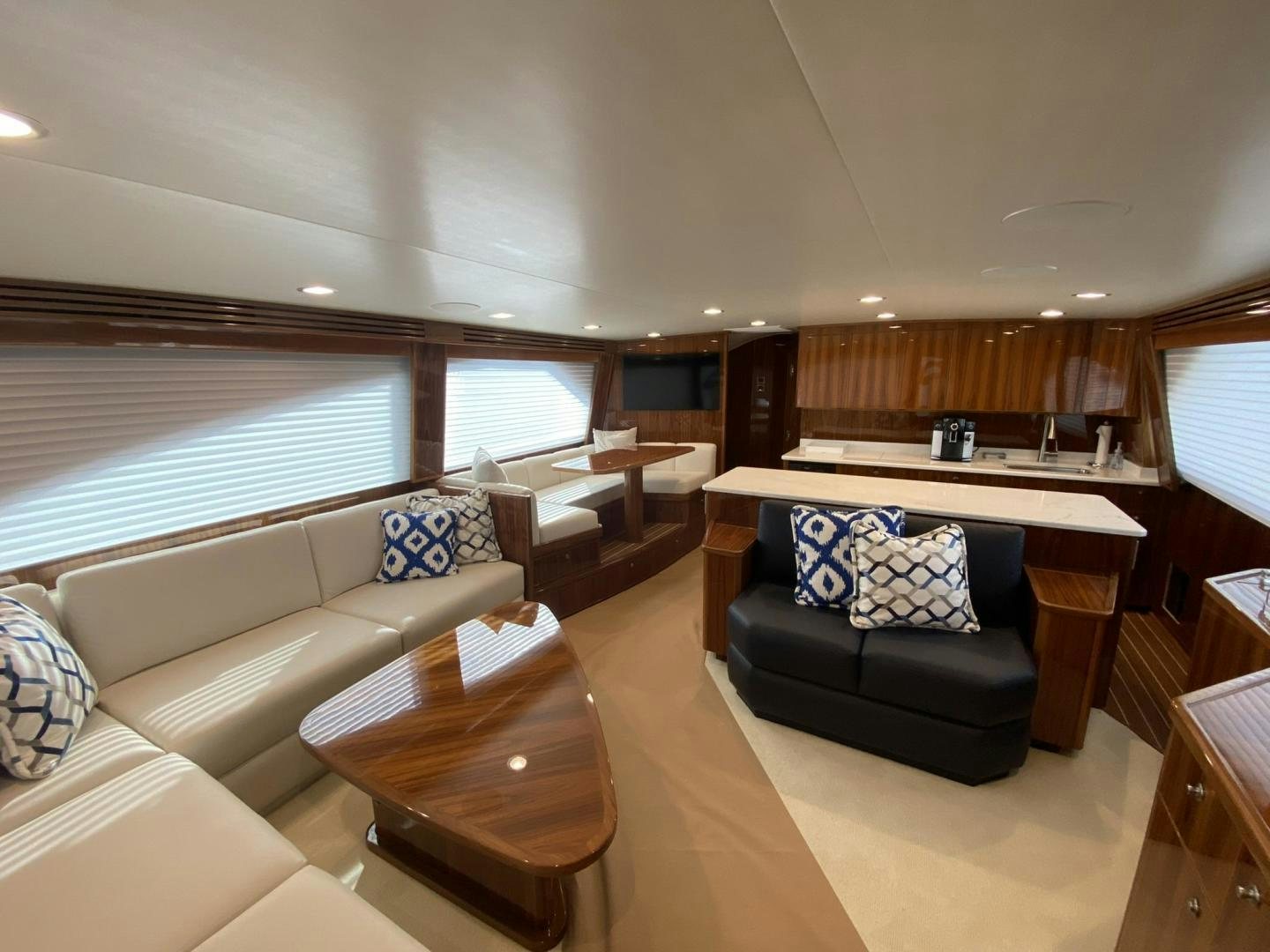 a living room with a couch and a table aboard Make It Happen Yacht for Sale