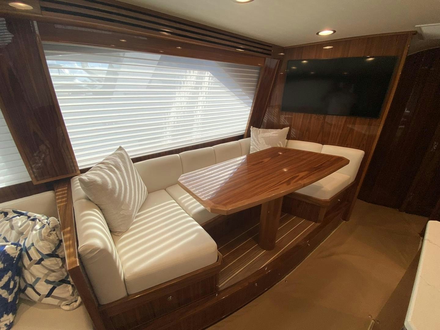 a room with a table and chairs aboard Make It Happen Yacht for Sale