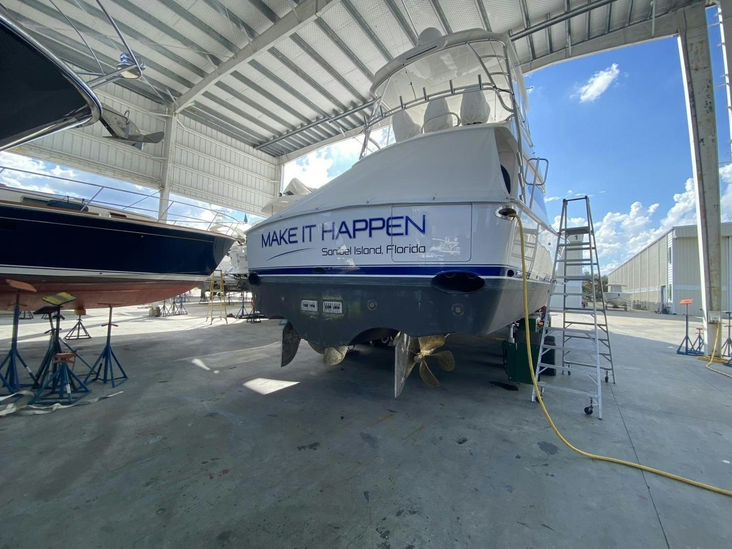 a large white truck parked under a roof aboard Make It Happen Yacht for Sale