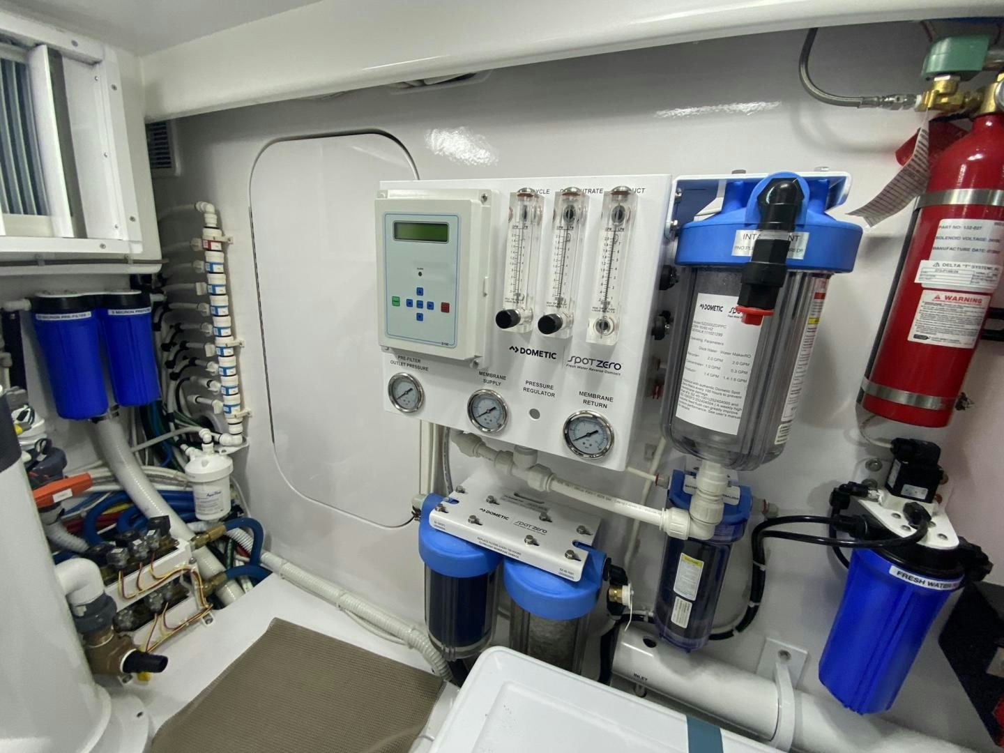 a white machine with blue tubes aboard Make It Happen Yacht for Sale