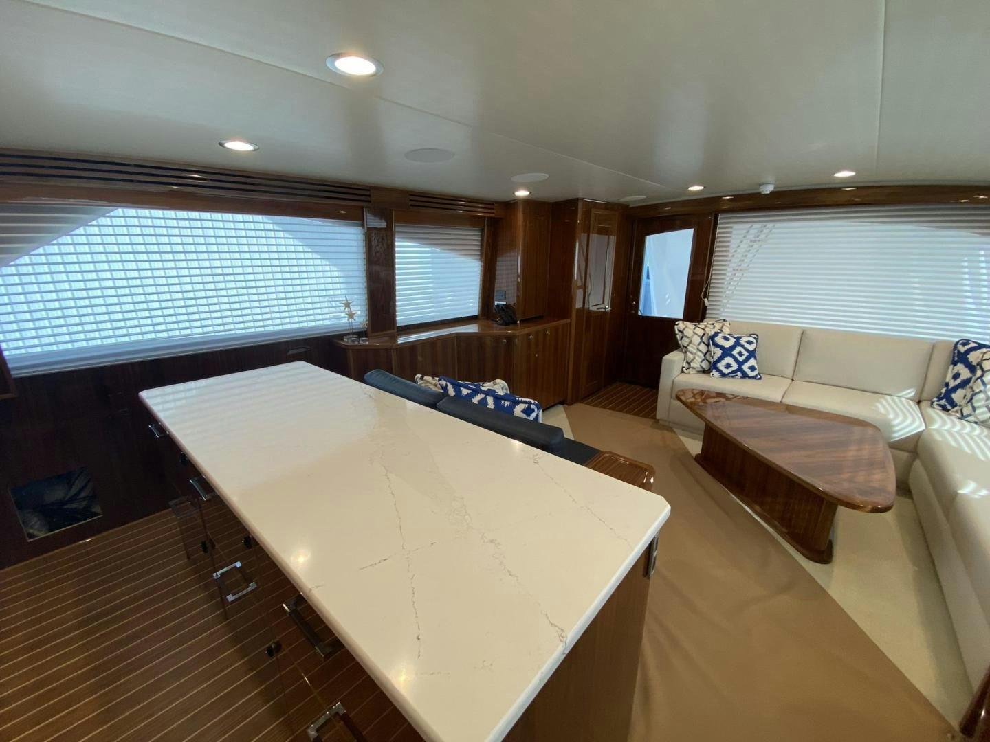 a large room with a table and couches aboard Make It Happen Yacht for Sale
