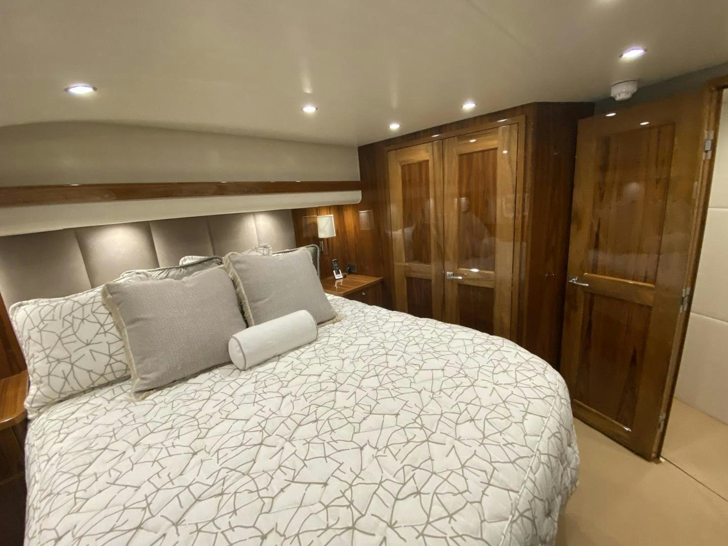 a bed with white sheets aboard Make It Happen Yacht for Sale