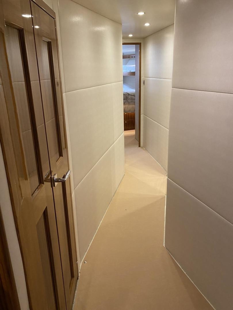a hallway with a door and a mirror aboard Make It Happen Yacht for Sale