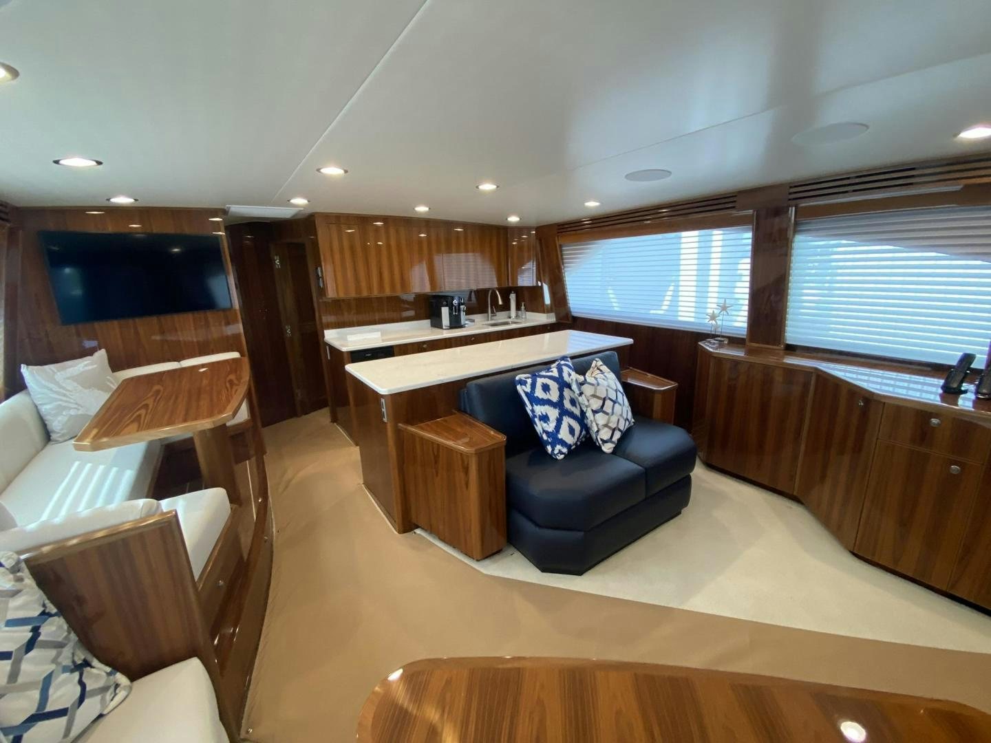 a living room with a couch and a table aboard Make It Happen Yacht for Sale