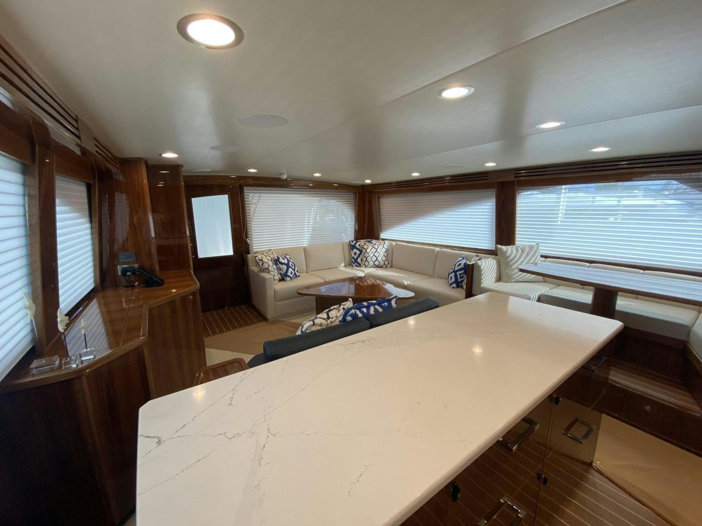 a large living room with a large bed and a large window aboard Make It Happen Yacht for Sale
