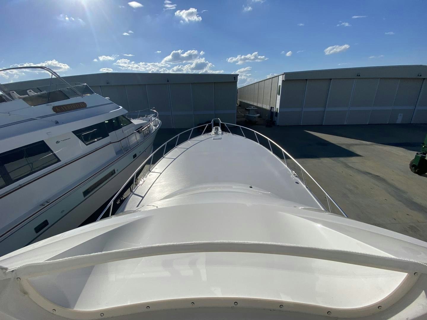 a white boat in a large building aboard Make It Happen Yacht for Sale