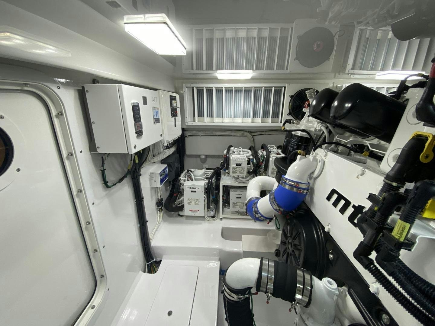 a person in a white coat and gloves working on a machine aboard Make It Happen Yacht for Sale