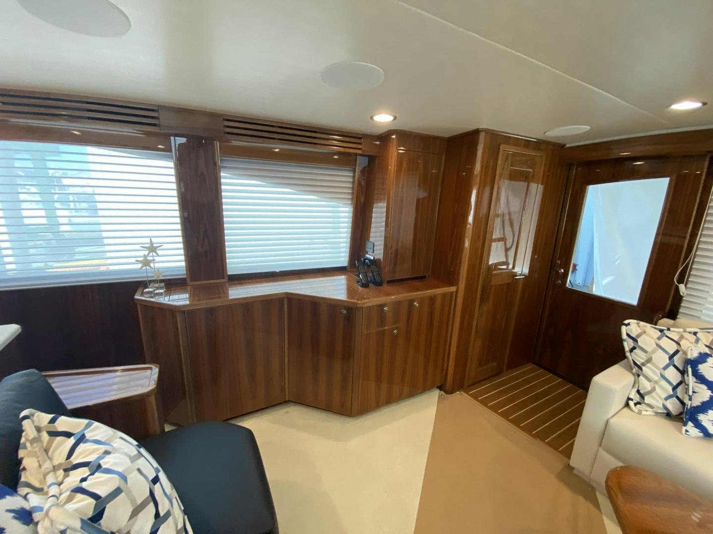 a room with a wood cabinet and a couch aboard Make It Happen Yacht for Sale