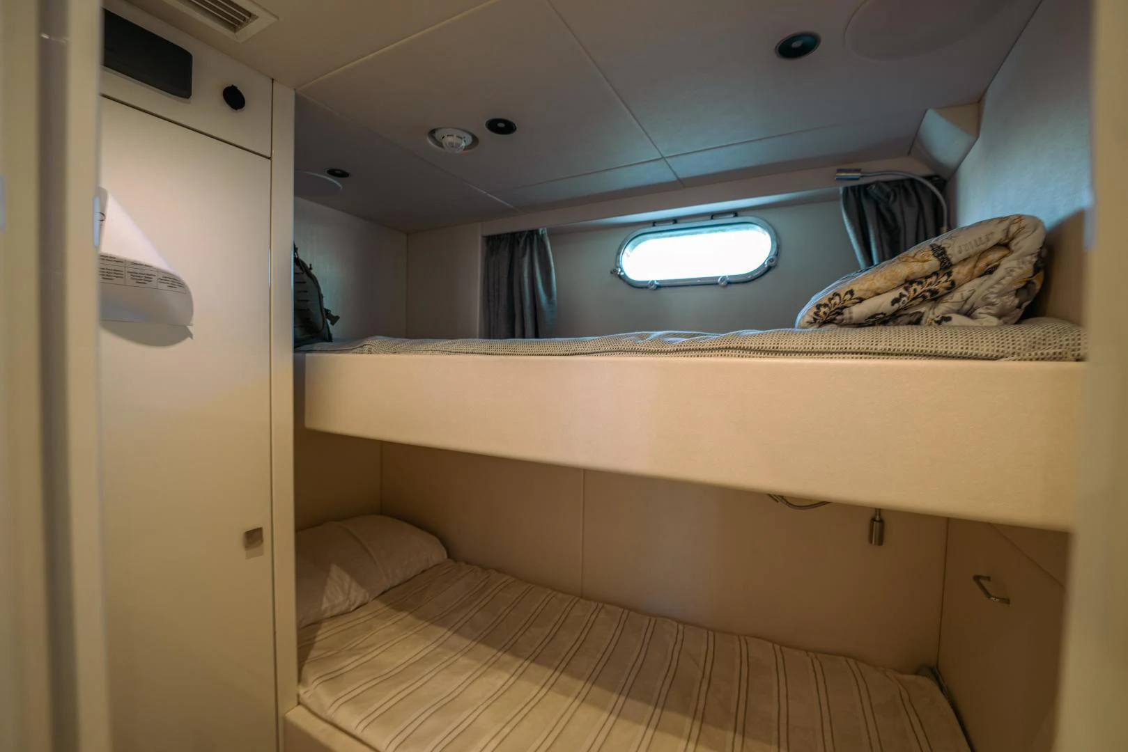 a room with a bed and a window aboard EOS Yacht for Sale