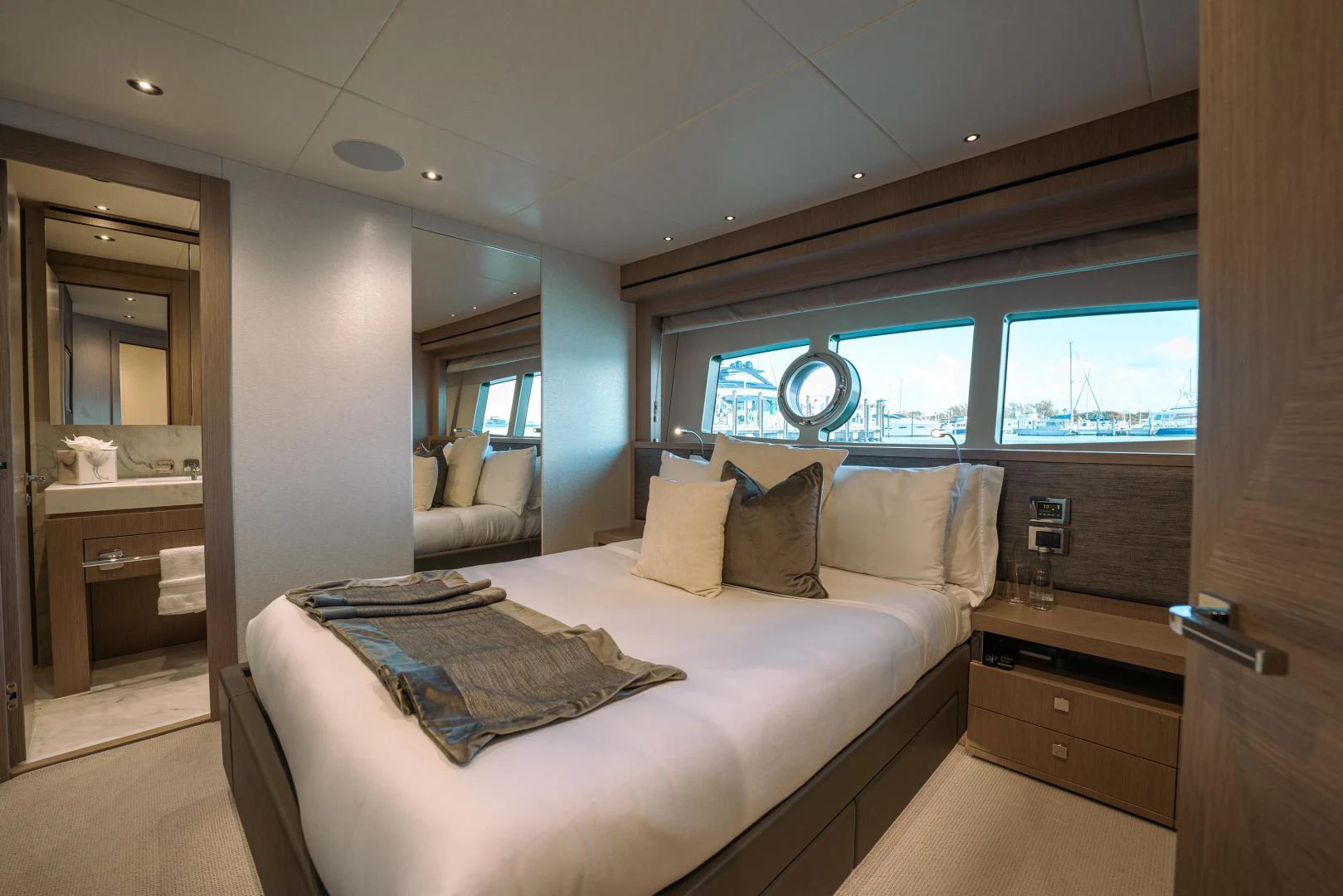 a bedroom with a bed and a window aboard EOS Yacht for Sale