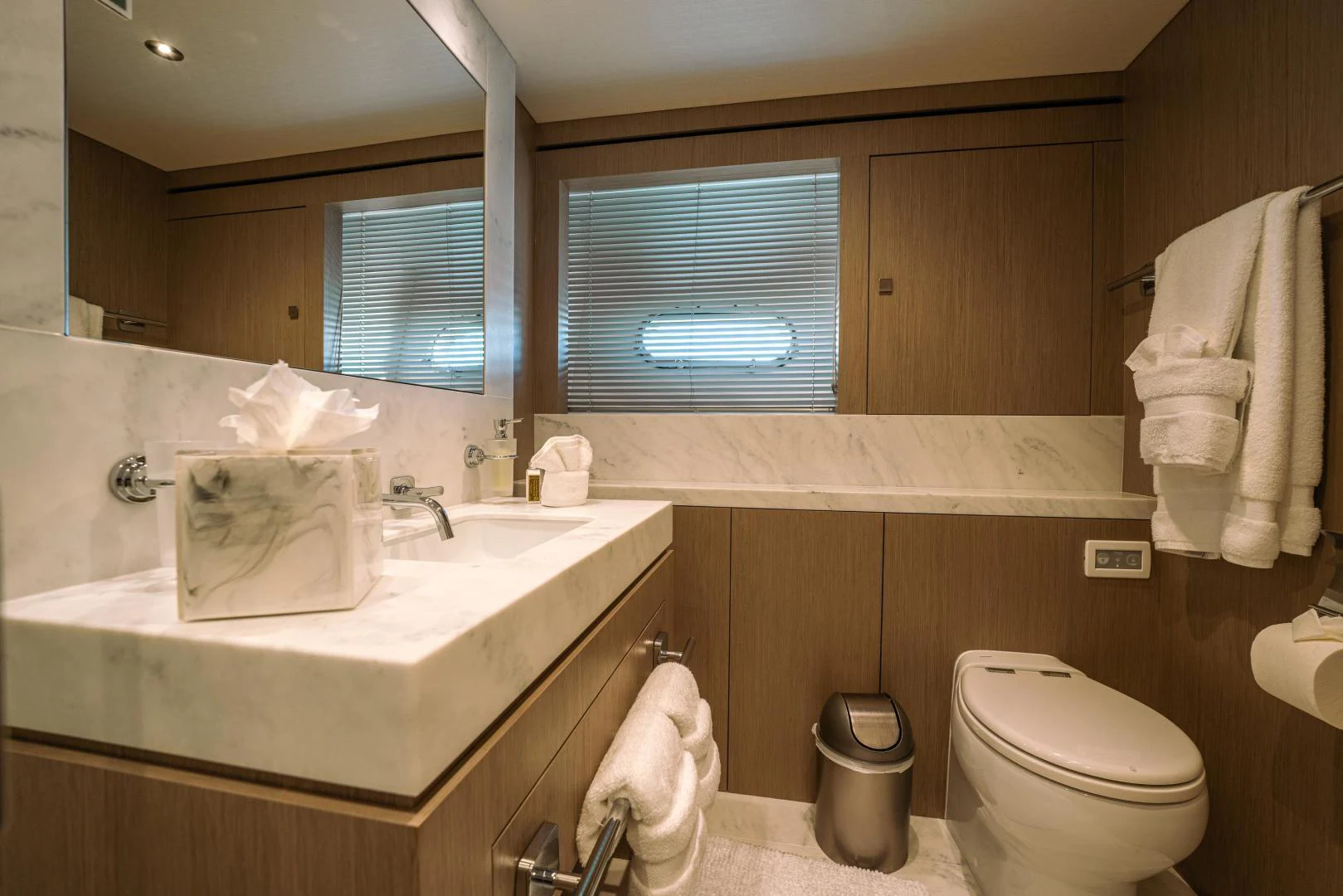 a bathroom with a sink toilet and a mirror aboard EOS Yacht for Sale