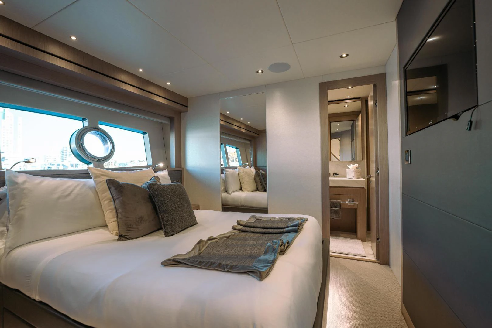 a bedroom with a bed and a window aboard EOS Yacht for Sale