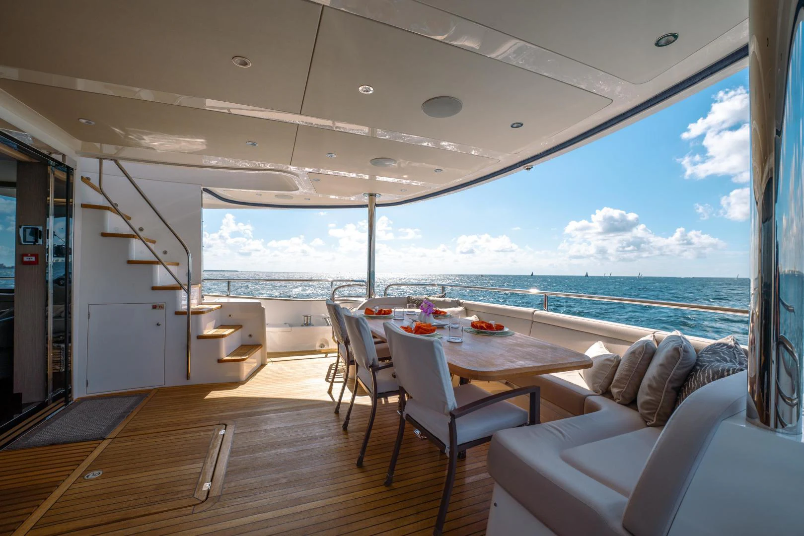 a large balcony overlooking a beach aboard EOS Yacht for Sale