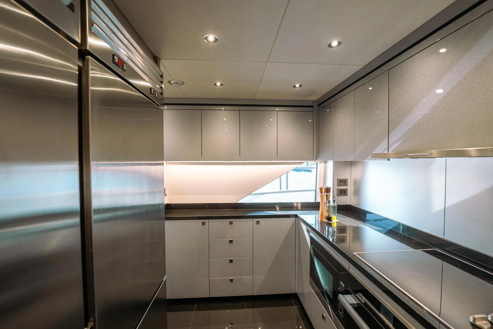 a kitchen with a glass wall aboard EOS Yacht for Sale