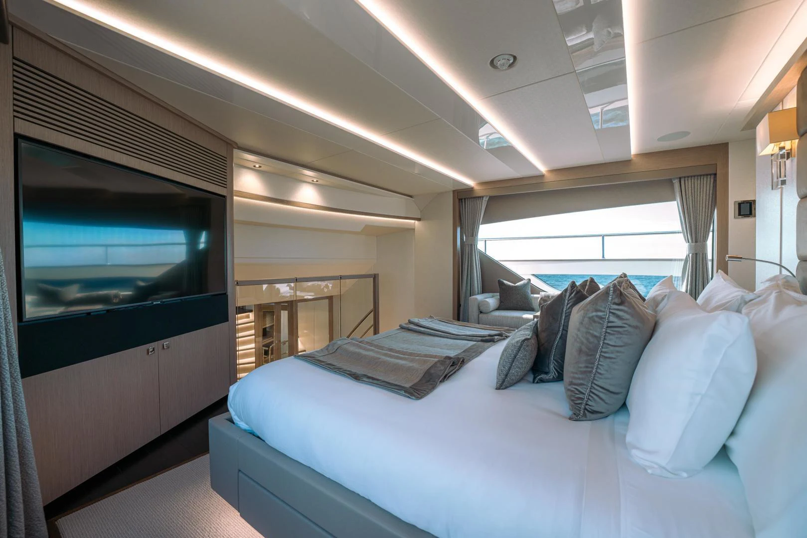 a room with a bed and a television aboard EOS Yacht for Sale