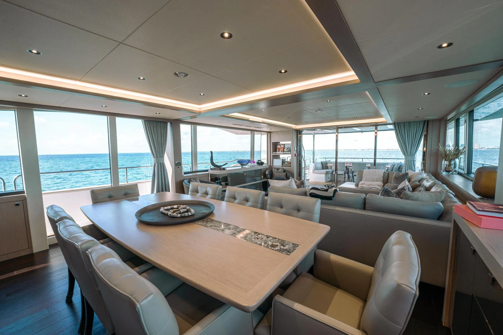 a large living room with a large table and chairs aboard EOS Yacht for Sale