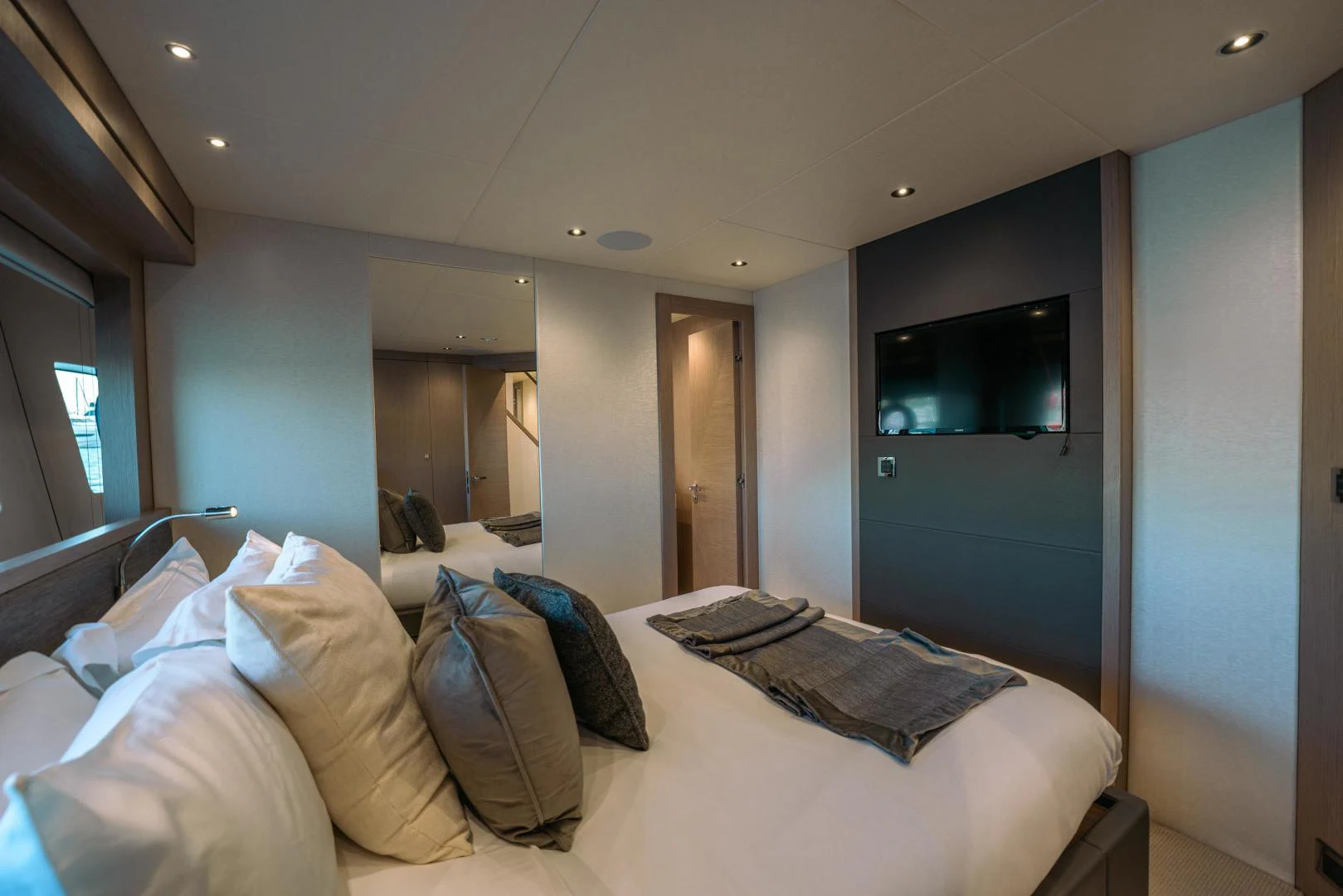 a bedroom with a bed and a television aboard EOS Yacht for Sale
