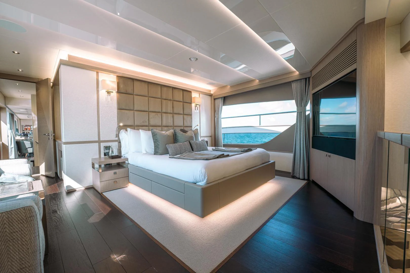a room with a bed and a large window aboard EOS Yacht for Sale