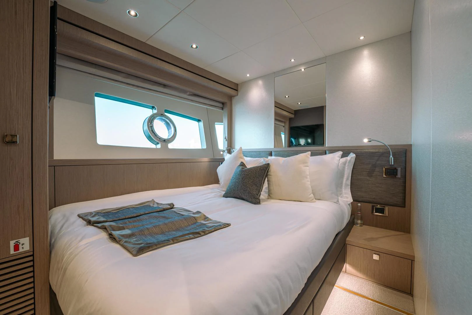 a bed with a white bed spread aboard EOS Yacht for Sale
