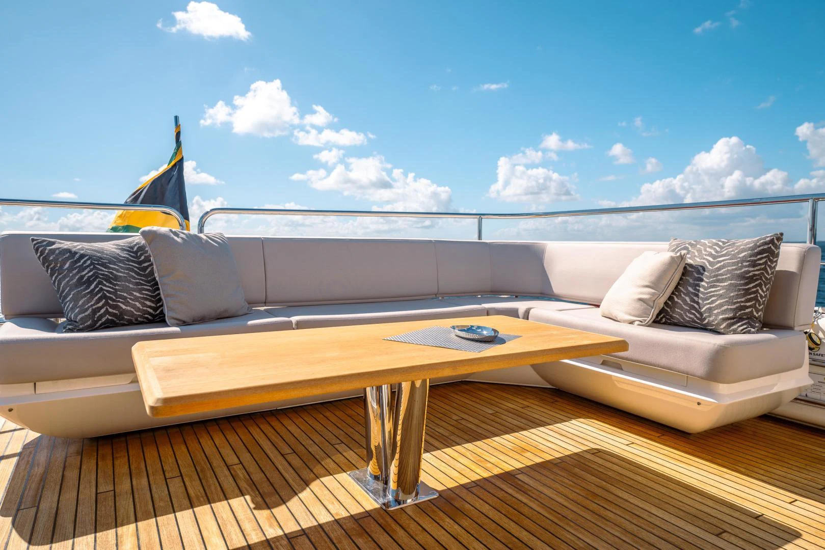 a couch and a table on a beach aboard EOS Yacht for Sale