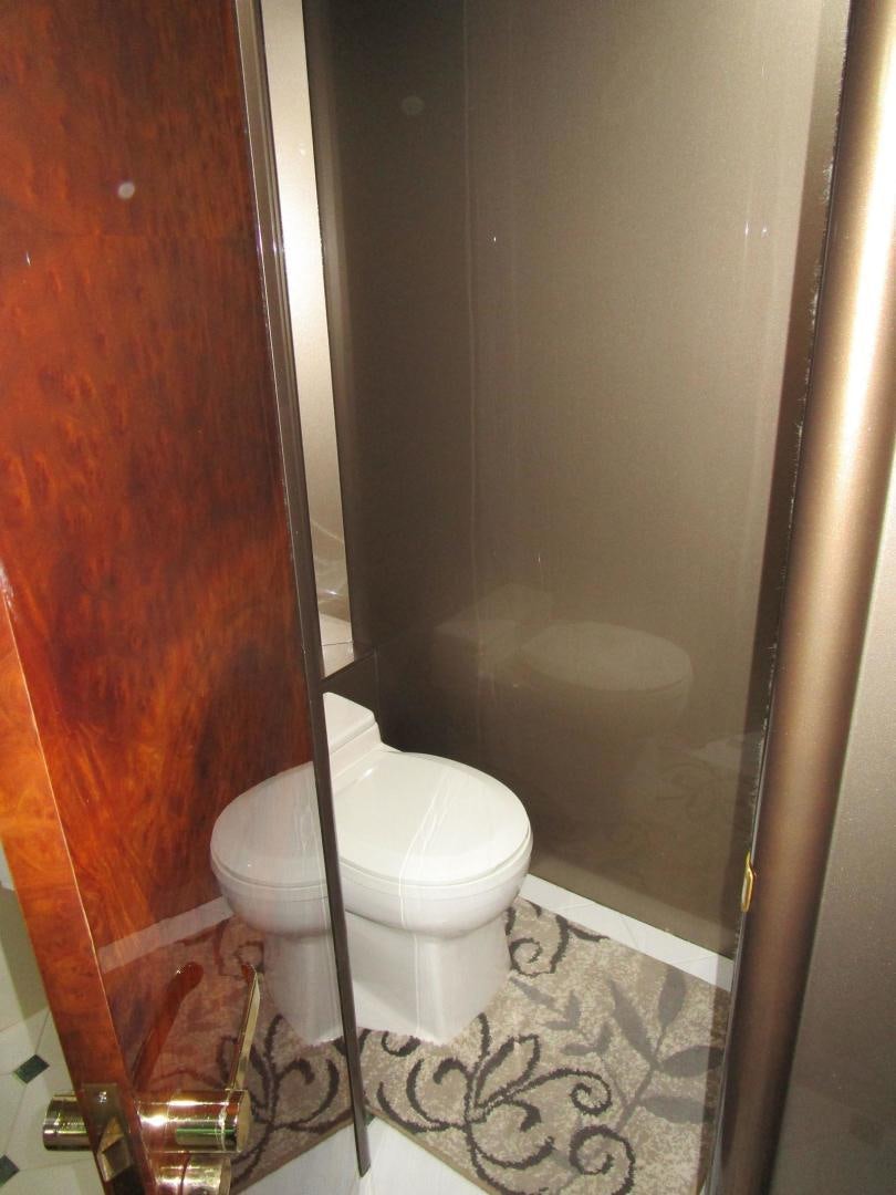 a toilet sits in a bathroom aboard MAGNIFICENT DOLLS Yacht for Sale