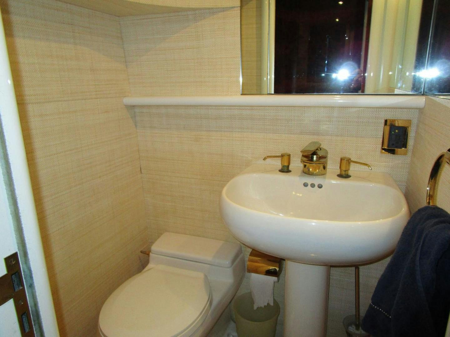 a bathroom with a sink and toilet aboard MAGNIFICENT DOLLS Yacht for Sale