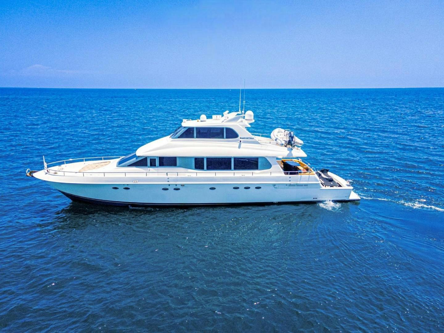 a white yacht in the water aboard MAGNIFICENT DOLLS Yacht for Sale