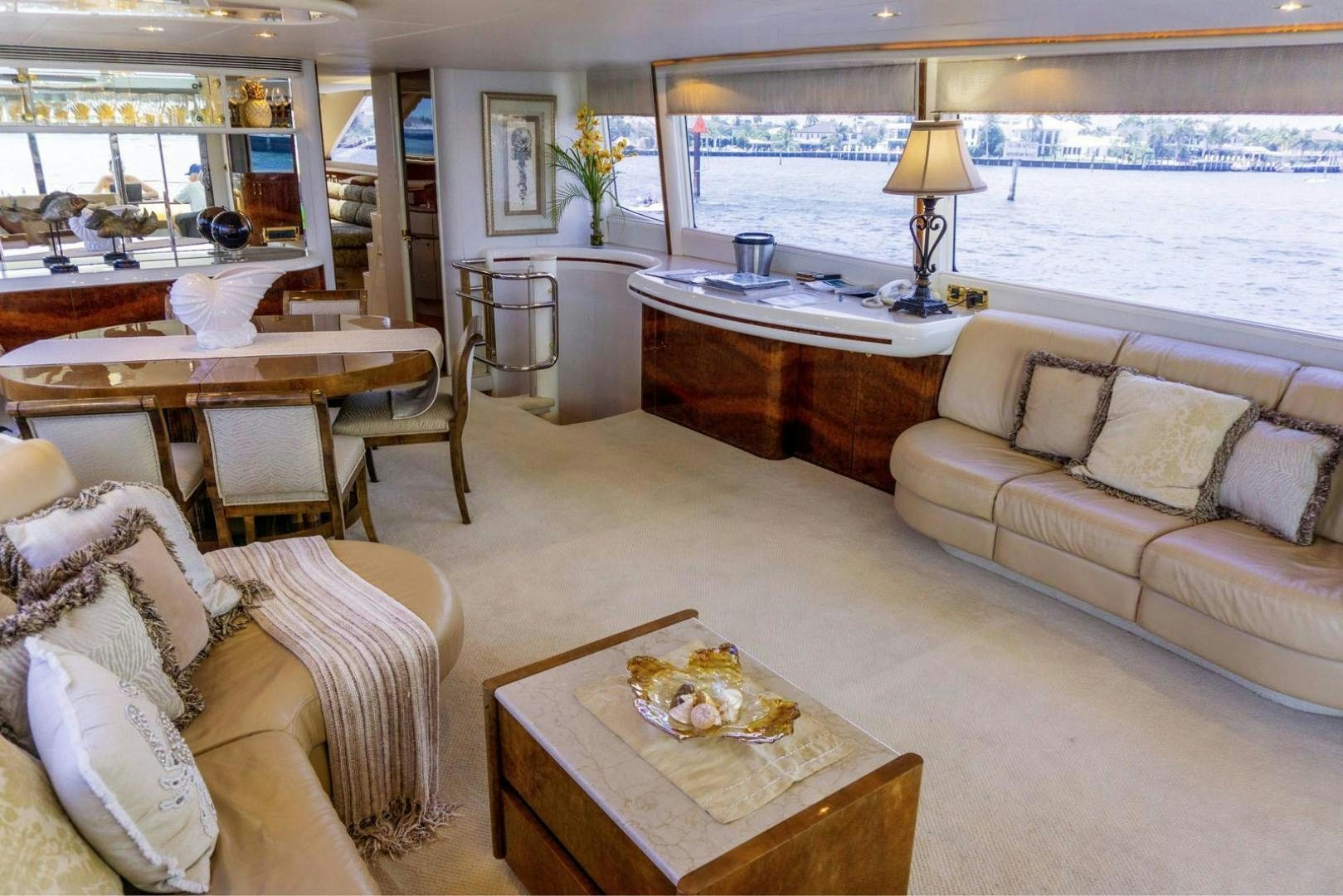 a living room with a table and couches aboard MAGNIFICENT DOLLS Yacht for Sale