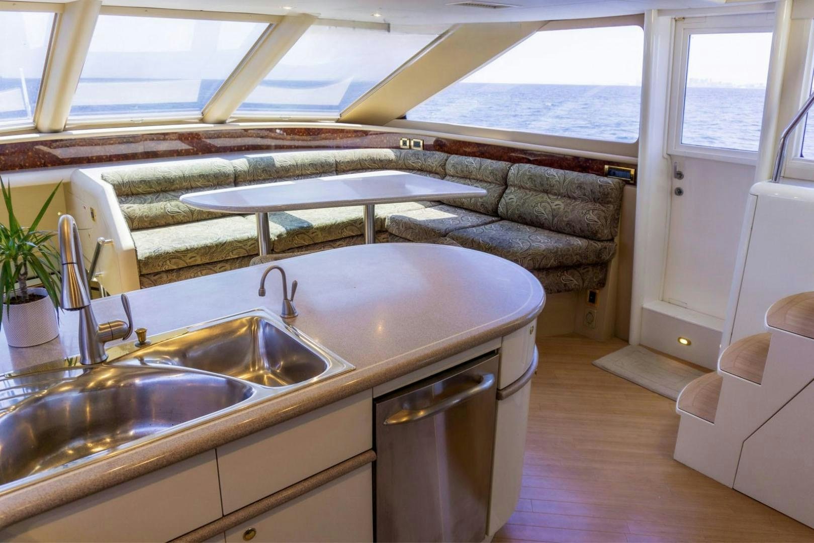 a kitchen with a sink and a couch aboard MAGNIFICENT DOLLS Yacht for Sale