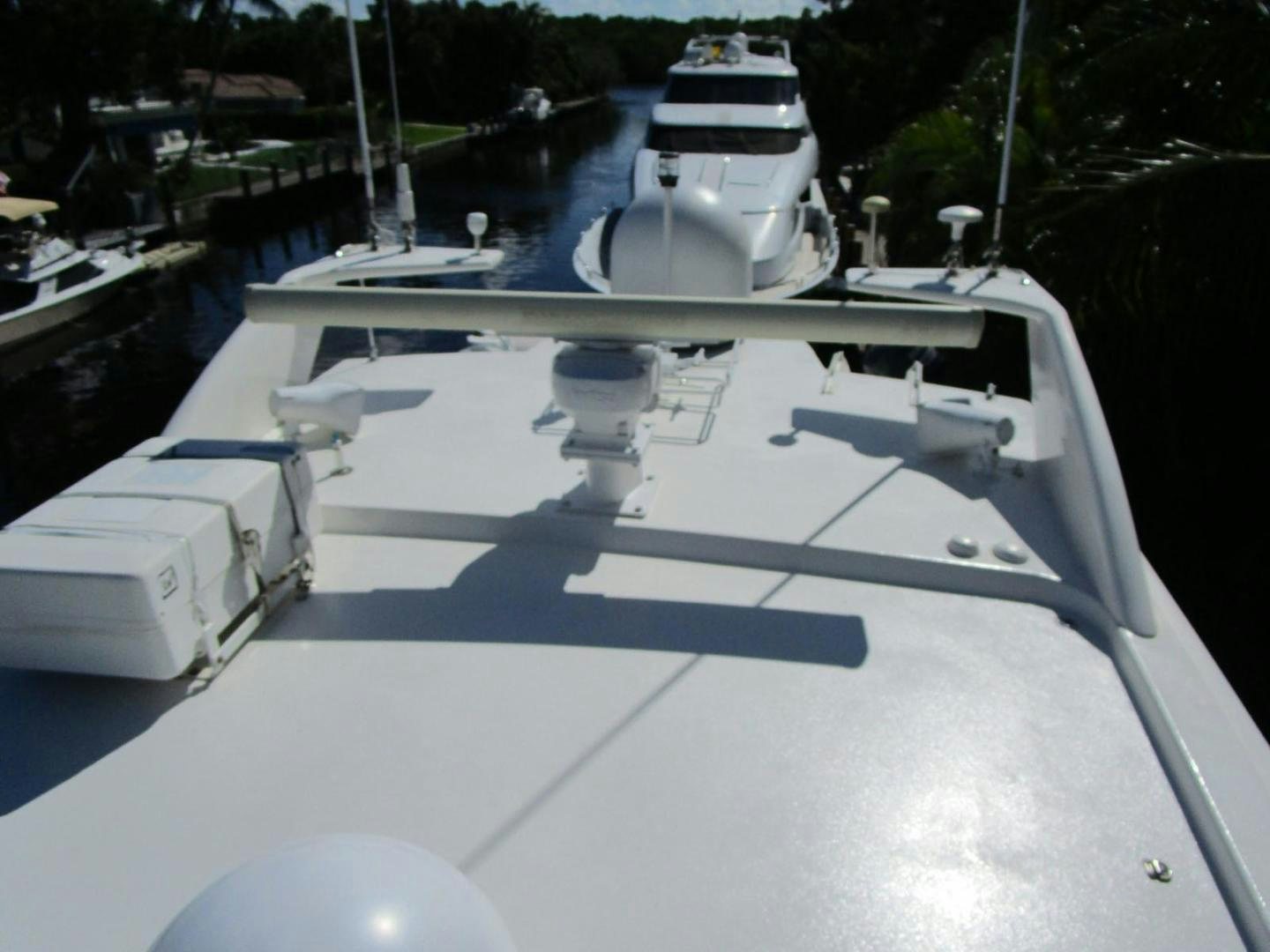 a white boat on a dock aboard MAGNIFICENT DOLLS Yacht for Sale