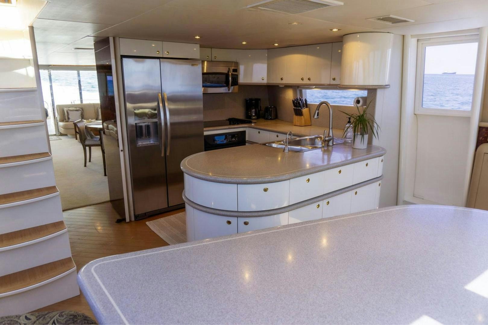 a kitchen with a stainless steel refrigerator aboard MAGNIFICENT DOLLS Yacht for Sale