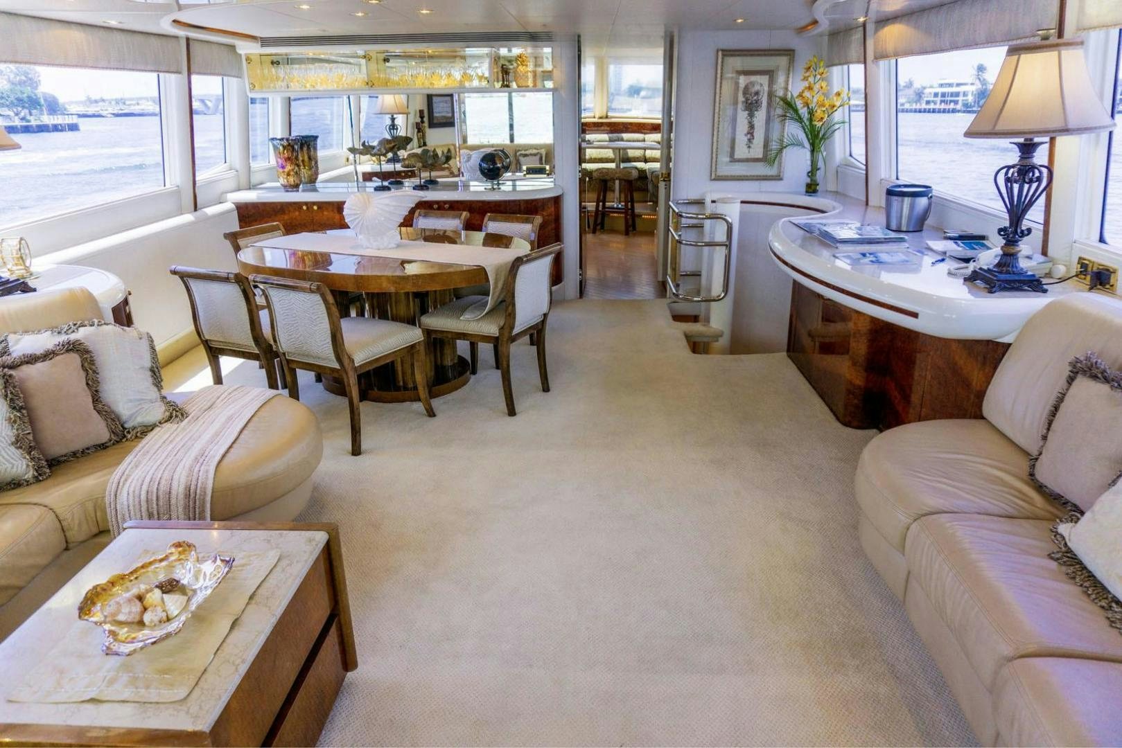 a living room with a table and chairs aboard MAGNIFICENT DOLLS Yacht for Sale