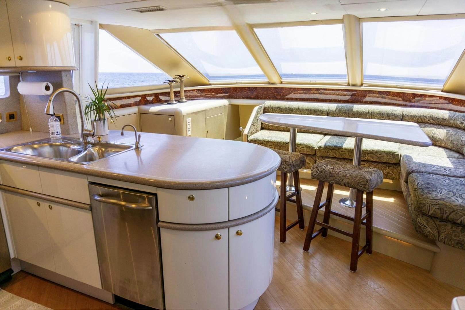 a kitchen with a sink and a table aboard MAGNIFICENT DOLLS Yacht for Sale