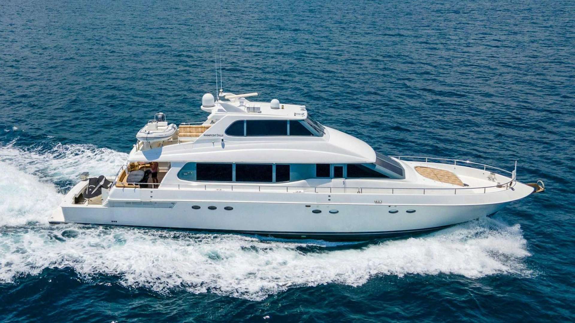 a white yacht on the water aboard MAGNIFICENT DOLLS Yacht for Sale