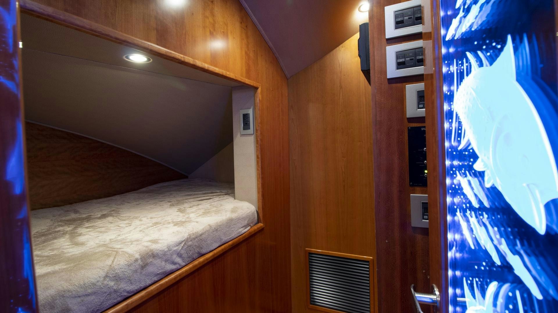 a room with a bed and a window aboard VICTORY Yacht for Sale