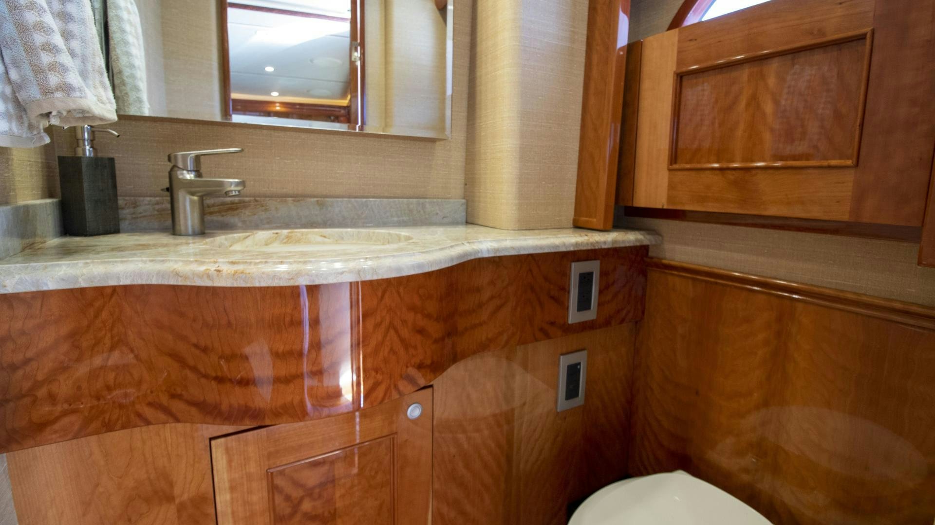 a bathroom with a sink and cabinets aboard VICTORY Yacht for Sale