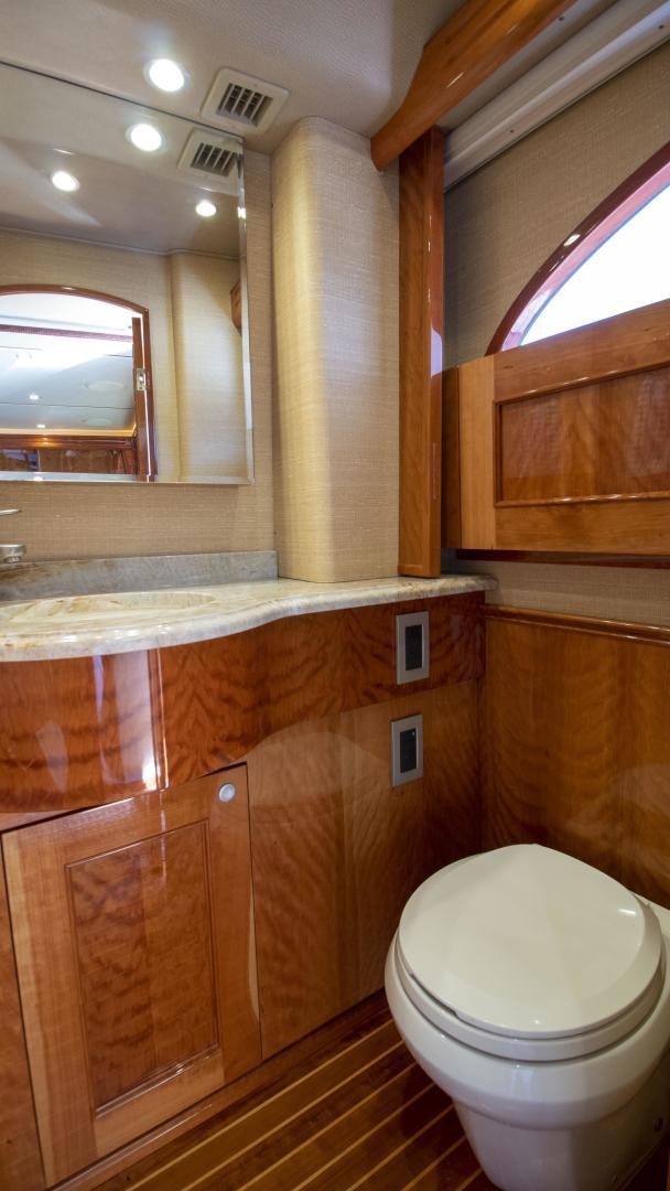 a bathroom with a toilet and a mirror aboard VICTORY Yacht for Sale