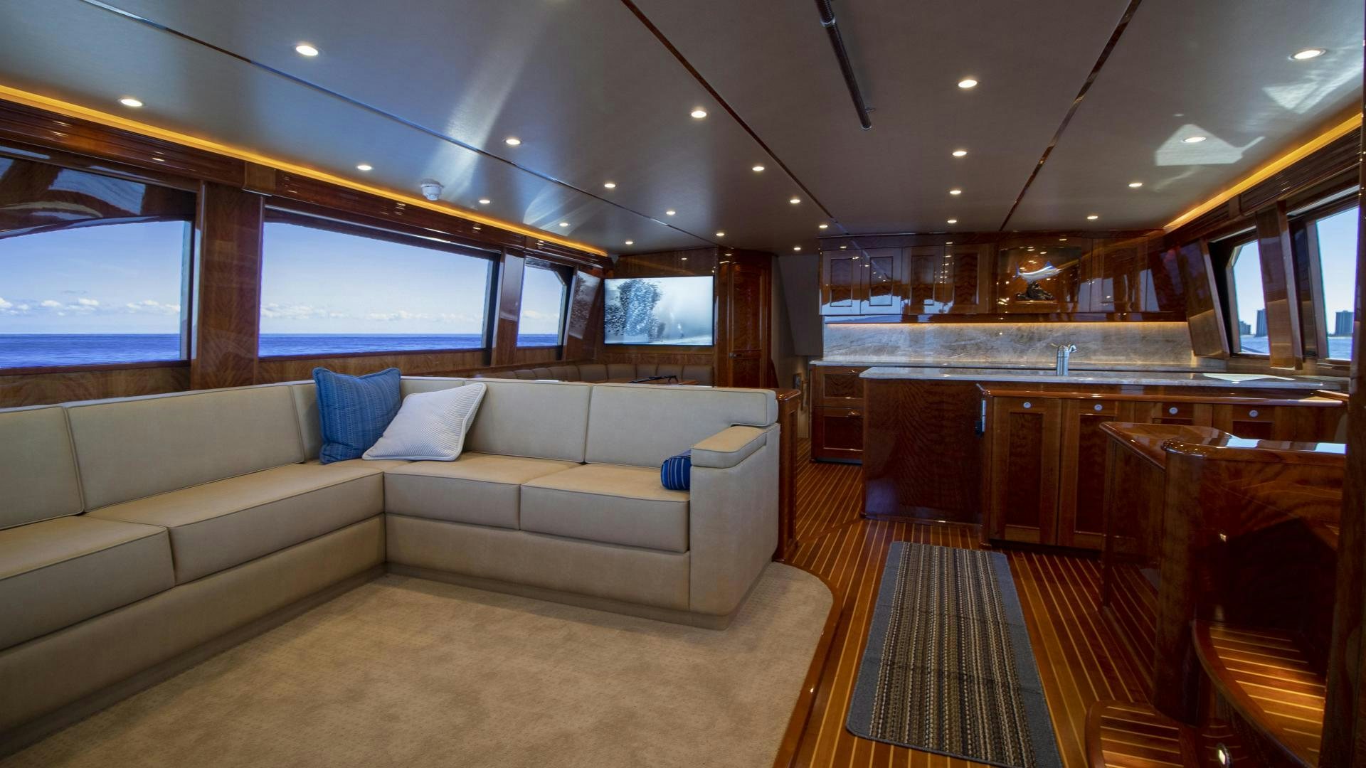 a living room with a couch and a large window aboard VICTORY Yacht for Sale